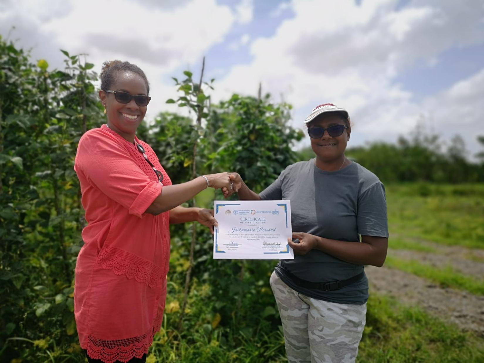 Dr. Gillian Smith handing over a certificate to Jaikumarie Persaud