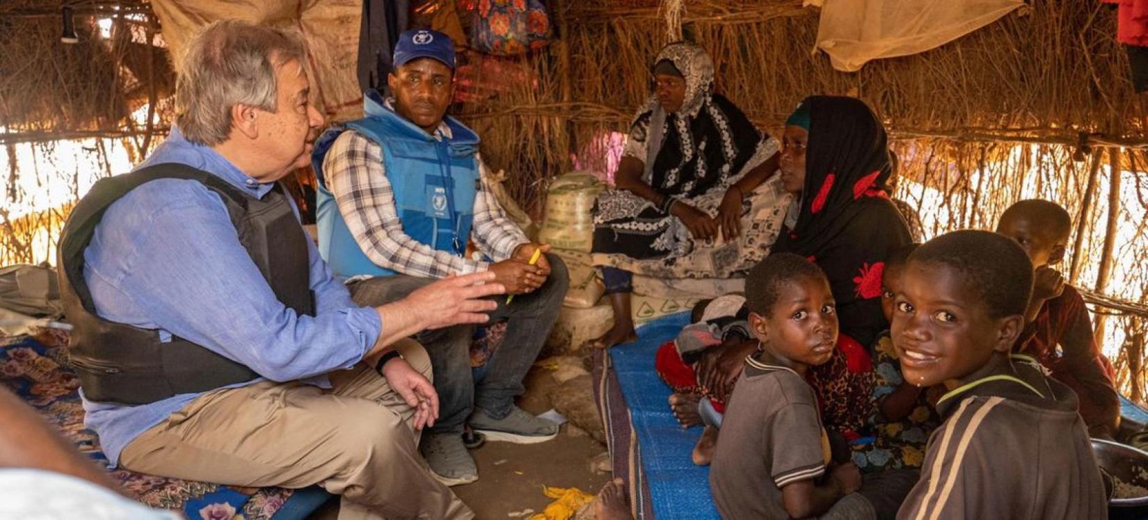 UN Secretary-General António Guterres sits with a family of internally displaced people at a camp in Baidoa in southwestern Somalia..