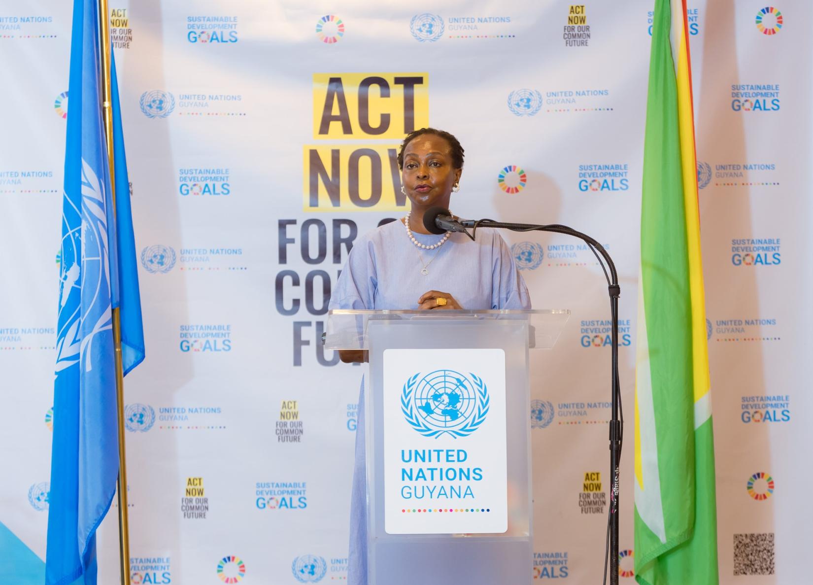 A woman standing at a podium speaking.