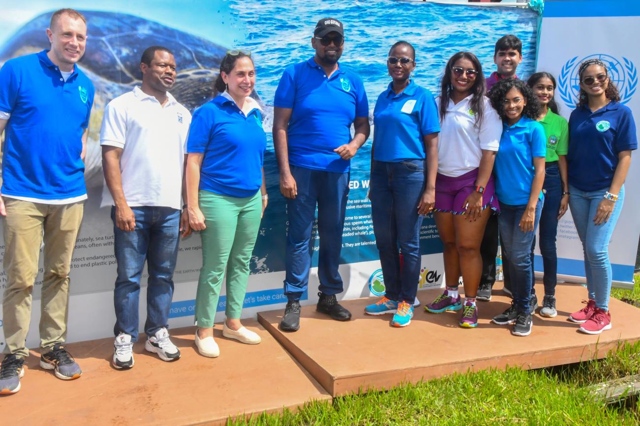 H.E. Dr. Mohamed Irfaan Ali, President of the Cooperative Republic of Guyana; Yeşim Oruç, UN Resident Coordinator and UN staff; and stakeholders after the unveiling of the climate themed wall arts.