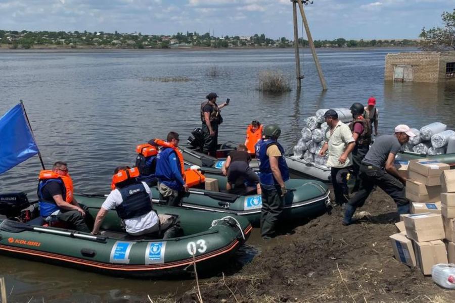 2 boats being loaded with supplies.