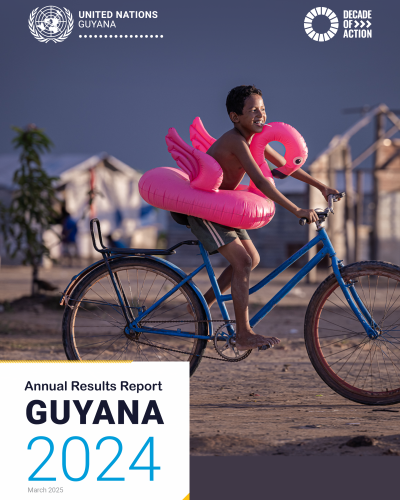 A photo of a report cover with a title - Annual Reports Report Guyana 2024. It has a photo of a boy on a bicycle with a pink inflatable flamingo around his waist.