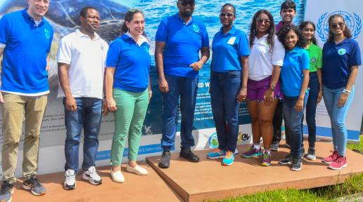 H.E. Dr. Mohamed Irfaan Ali, President of the Cooperative Republic of Guyana; Yeşim Oruç, UN Resident Coordinator and UN staff; and stakeholders after the unveiling of the climate themed wall arts.