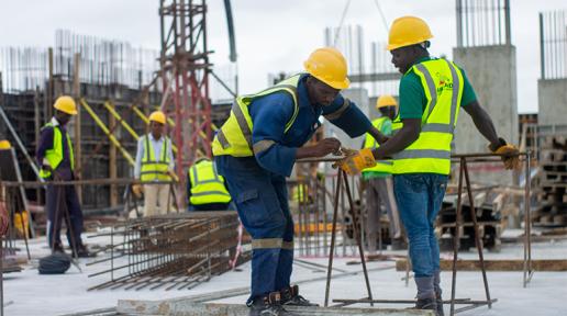 Photo of men in safety gear at a construction site.