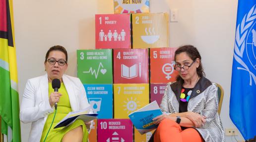 Two ladies seated. One holding a microphone.