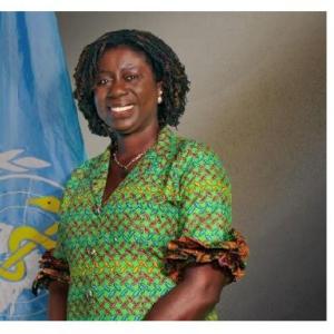 Photo of a woman standing in front of a UN flag